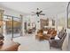 Bright, open-concept living room featuring tile floors, ample seating, and seamless access to the dining and kitchen areas at 11551 30Th E Cv, Parrish, FL 34219