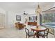 Open living space with dining area, tiled floors, and views of the outdoor pool area at 11551 30Th E Cv, Parrish, FL 34219