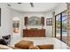 Spacious living room with tiled floors, archways, and a view of the pool area at 11551 30Th E Cv, Parrish, FL 34219