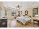 Spacious main bedroom with a tray ceiling, light hardwood floors, and natural light at 11551 30Th E Cv, Parrish, FL 34219