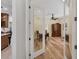 Office with an armoire and doorway to the kitchen area at 11551 30Th E Cv, Parrish, FL 34219