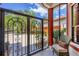 Enclosed patio featuring decorative ironwork, comfortable seating, and views of the surrounding neighborhood at 11551 30Th E Cv, Parrish, FL 34219