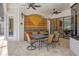 An outdoor dining space with six chairs, a table, and a decorative tile backsplash at 11551 30Th E Cv, Parrish, FL 34219