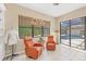 Relaxing sitting room with comfortable chairs and a view of the pool and outdoor area at 11551 30Th E Cv, Parrish, FL 34219