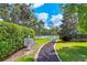 Path to the lake with serene views, sign for property rights, and mature trees at 11551 30Th E Cv, Parrish, FL 34219