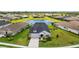 Aerial view of home in community with lake, lush landscaping, and well-maintained lawns at 11719 Chevelon Ln, Parrish, FL 34219
