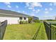 Lush backyard bordered by a fence, with views of the lake and screened in lanai at 11719 Chevelon Ln, Parrish, FL 34219