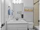 Bright bathroom with beach themed wall decor, shower-tub combination, and modern fixtures at 11719 Chevelon Ln, Parrish, FL 34219