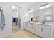 Modern bathroom featuring dual vanities, and a walk-in closet at 11719 Chevelon Ln, Parrish, FL 34219