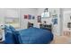 Bright bedroom with blue comforter, featuring fun decor and adjacent hallway access at 11719 Chevelon Ln, Parrish, FL 34219