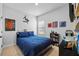 Comfortable bedroom featuring a blue comforter, playful decor, and ample natural light at 11719 Chevelon Ln, Parrish, FL 34219