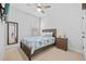 Bright bedroom with a ceiling fan, window, and coastal-themed decor at 11719 Chevelon Ln, Parrish, FL 34219