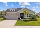 Charming single-story home with a two car garage, stone accents, and lush landscaping at 11719 Chevelon Ln, Parrish, FL 34219