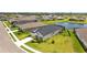 New construction with a manicured lawn and a lake in the backyard at 11719 Chevelon Ln, Parrish, FL 34219