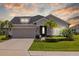 Charming single-story home with a two car garage, stone accents, and lush landscaping at 11719 Chevelon Ln, Parrish, FL 34219