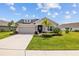 Beautiful single-story home with manicured lawn, stone accents, and an attached garage at 11719 Chevelon Ln, Parrish, FL 34219