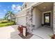 Close up of home's stone pillar entry with a lush, well-manicured landscaped yard at 11719 Chevelon Ln, Parrish, FL 34219