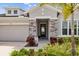 Inviting front porch with stone pillars and a 'Welcome' sign, framed by lush landscaping at 11719 Chevelon Ln, Parrish, FL 34219