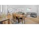 Bright open-concept living and dining area with modern decor and wood flooring at 11719 Chevelon Ln, Parrish, FL 34219