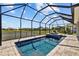 Screened pool boasts serene water views, an integrated spa, and paved surround at 11719 Chevelon Ln, Parrish, FL 34219