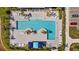 Aerial view of community swimming pool with sundeck, lounge chairs, and lush landscaping at 11719 Chevelon Ln, Parrish, FL 34219