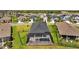 Aerial view of a home with a screened-in pool and outdoor seating at 11719 Chevelon Ln, Parrish, FL 34219