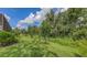 A lush green backyard features beautifully manicured lawn with young trees lining the rear property line at 13130 50Th E Ct, Parrish, FL 34219