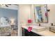 Stylish bathroom vanity with sleek black cabinets, white countertop, and gold faucet at 13130 50Th E Ct, Parrish, FL 34219