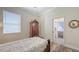 Well lit bedroom with a window, wooden chest and decoratively framed mirror at 13130 50Th E Ct, Parrish, FL 34219