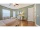 Comfortable bedroom with hardwood floors, dresser, and a ceiling fan for a relaxing space at 13130 50Th E Ct, Parrish, FL 34219