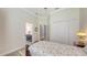 Bedroom with a peek into a bathroom shows a patterned tile floor at 13130 50Th E Ct, Parrish, FL 34219