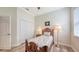 Cozy bedroom features a white closet, a wooden bed frame, and a bright window at 13130 50Th E Ct, Parrish, FL 34219
