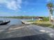 Boat ramp featuring two docks, a information kiosk, and lush treeline in the background at 13130 50Th E Ct, Parrish, FL 34219