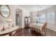The elegant dining room features wood floors, a chandelier, and bright windows with views of the outdoors at 13130 50Th E Ct, Parrish, FL 34219