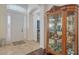 A spacious foyer boasts tile flooring, an elegant china cabinet, and a front door with sidelights at 13130 50Th E Ct, Parrish, FL 34219