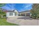 The home's front exterior features a wide driveway, a three car garage, and a well maintained lawn at 13130 50Th E Ct, Parrish, FL 34219