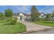Stunning home features lush landscaping, a blue front door, and a winding driveway, adding to its curb appeal at 13130 50Th E Ct, Parrish, FL 34219