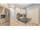 Spacious kitchen offering stainless steel appliances, ample storage in light cabinetry, and a functional center island at 13130 50Th E Ct, Parrish, FL 34219