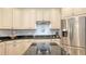 Updated kitchen featuring granite countertops, stainless steel appliances, light cabinetry, and modern fixtures at 13130 50Th E Ct, Parrish, FL 34219
