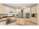 Well-lit kitchen featuring stainless steel appliances, light cabinetry, and granite countertops for a modern, elegant cooking space at 13130 50Th E Ct, Parrish, FL 34219
