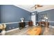 Bright living room featuring blue walls, crown molding, decorative furniture, and modern flooring at 13130 50Th E Ct, Parrish, FL 34219