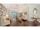 Charming living room features hardwood floors, tray ceilings, and a seamless connection to the outdoor patio area at 13130 50Th E Ct, Parrish, FL 34219
