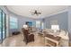 Inviting living room featuring tile floors, large windows, a ceiling fan, and comfortable seating for a relaxing ambiance at 13130 50Th E Ct, Parrish, FL 34219