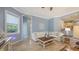 Relaxing living room with comfortable seating, tile floors, and a large window for natural light and a bright atmosphere at 13130 50Th E Ct, Parrish, FL 34219