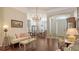The living room offers wood floors, a chandelier, and an open design perfect for easy flow and entertaining at 13130 50Th E Ct, Parrish, FL 34219