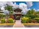 Entrance to a mini golf course with wooden details and lush landscaping under a sunny sky at 13130 50Th E Ct, Parrish, FL 34219