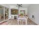 Covered patio with dining table, seating and view through a window at 13130 50Th E Ct, Parrish, FL 34219