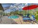 A luxurious screened in pool with lounge seating offers a relaxing space for entertaining and enjoying the outdoors at 13130 50Th E Ct, Parrish, FL 34219