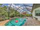 Sparkling screened-in pool with a brick surround, plus an outdoor lounge area and backyard views at 13130 50Th E Ct, Parrish, FL 34219