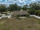 Aerial view of a home with an enclosed patio, fenced backyard, and mature trees at 13612 11Th E Ter, Bradenton, FL 34212